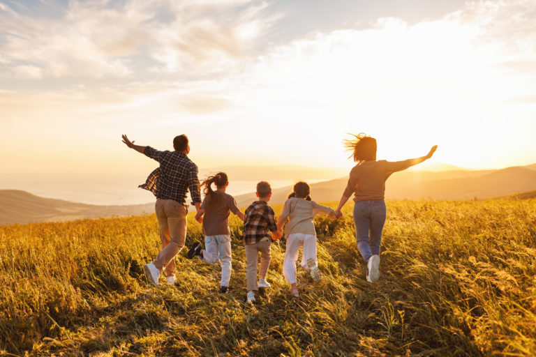 Happy large family: mother, father, children son and daughters on sunset